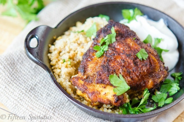 Indian Spice Rubbed Chicken Thighs in black Dish with Quinoa and Yogurt