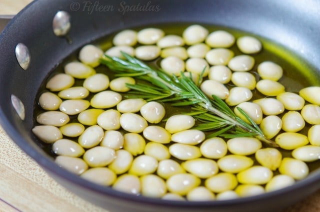 Marcona Almonds Cooking in Olive Oil and Rosemary Sprig