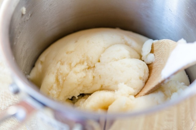 Cream Puff Dough In Saucepan With Wooden Spoon