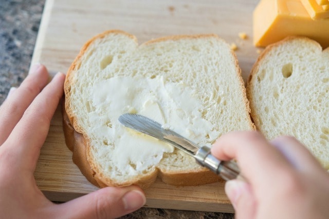 Spreading White Bread with Butter