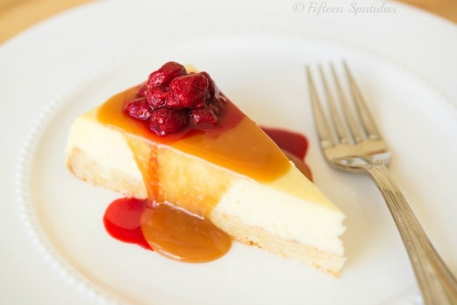 Caramel Cheesecake Slice on Plate with Raspberry Sauce and Fork