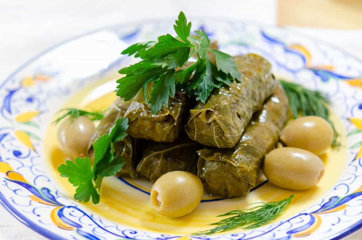 Pile of Dolmas On a Plate with olives