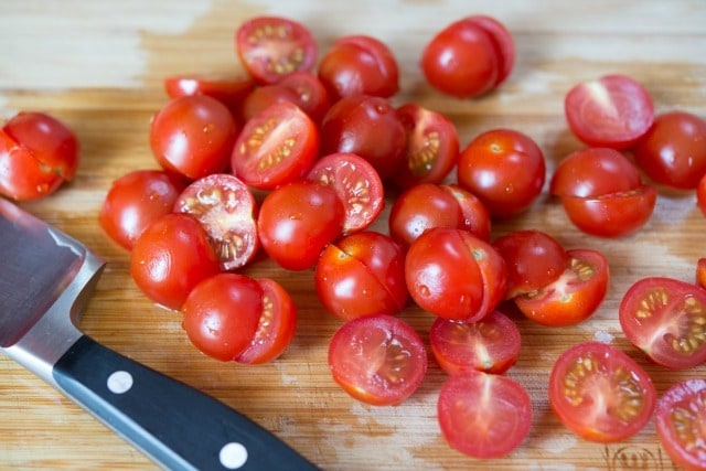 Halved Cherry Tomatoes on Cutting board