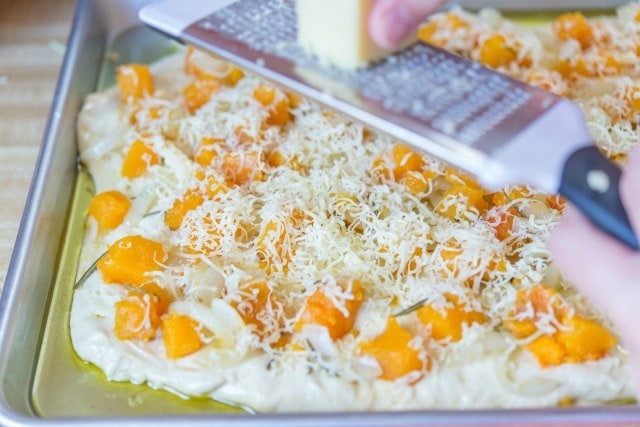 Grating Cheese on Top of Butternut Squash Focaccia