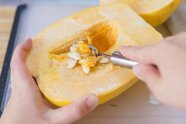 Scooping Seeds Out of Spaghetti Squash with Melon Baller