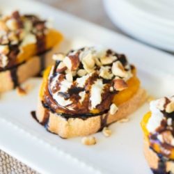 Butternut Squash Crostini On White Plate with ricotta and balsamic on top