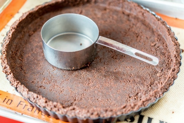 Chocolate Wafer Cookie Crumbs Pressed Into Tart Shell with Cup