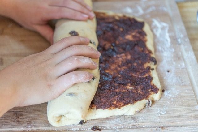 Rolling a Log of Cinnamon raisin Bread Dough Up tightly With the Filling