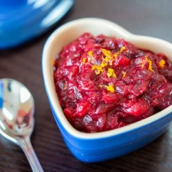 Cranberry Sauce In a Blue Heart Dish on Wooden Board