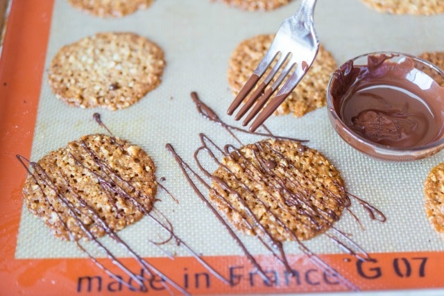 Drizzling Italian Lace Cookies with Milk Chocolate Using Fork