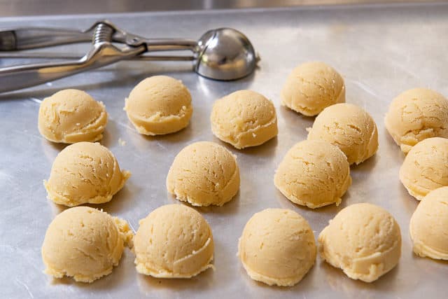 Scoops of Thumbprint Cookie Dough on Sheet Pan