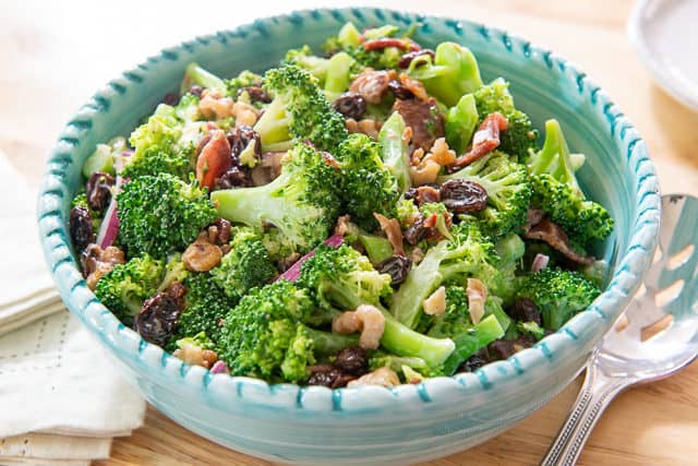 Broccoli Salad Recipe - Served in Blue Bowl on Wooden Board