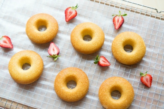 Six Baked Donuts with Strawberries on Wax Paper