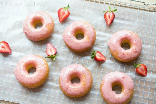 Strawberry Donuts On Wax Paper Lined Cooling Rack