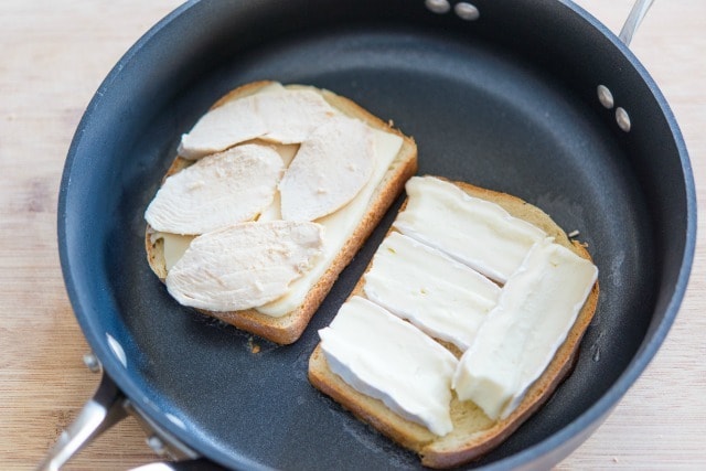 Two Slices of Bread Grilling with Chicken Slices and Sliced Brie