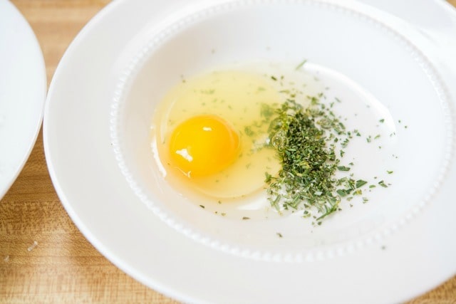 Egg and Minced Rosemary in a Bowl