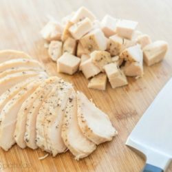 Cooked Crockpot Chicken Breast Cubed and Sliced on Cutting Board