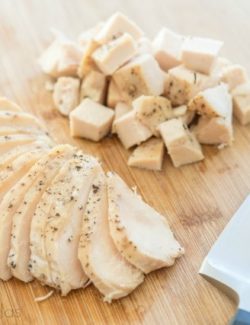 Cooked Crockpot Chicken Breast Cubed and Sliced on Cutting Board
