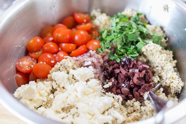 Feta, Tomatoes, Mint, and Kalamata Olives on top of quinoa in bowl