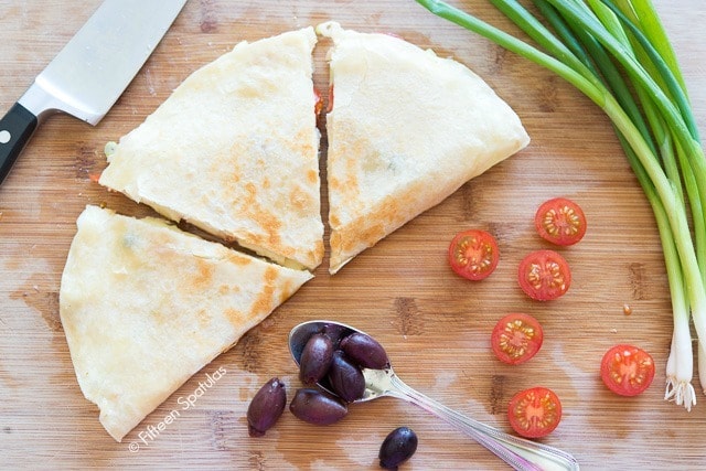 Greek Quesadillas On Cutting Board with Olives and Tomatoes