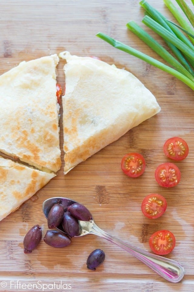 Greek Style Quesadillas - On Cutting Board with Olives and Tomatoes