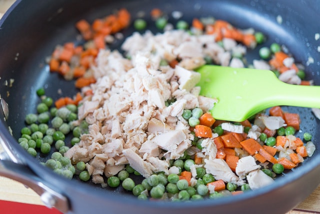 Peas, Chicken Carrots, and Onion Cooking in Skillet