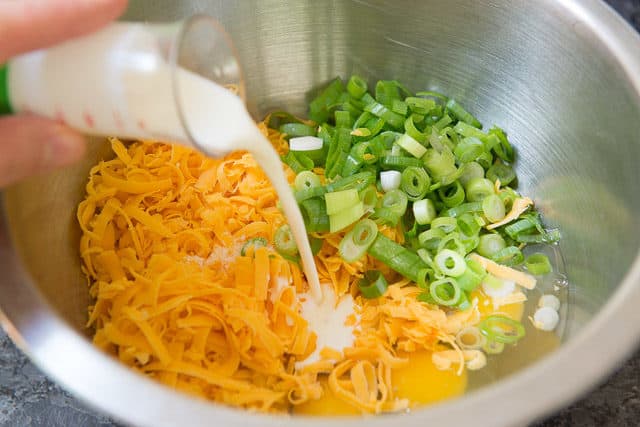Frittata Ingredients in bowl including Eggs, cheddar, cream, scallions