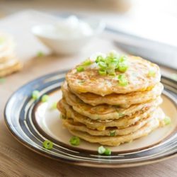 Savory Corn Pancakes - Stacked on a Plate and Garnished with Scallions
