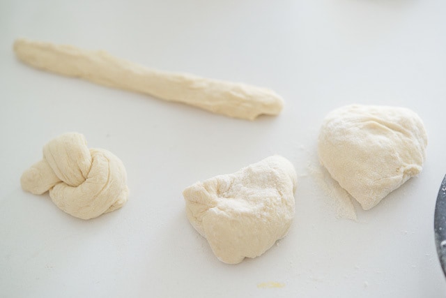 Pieces of garlic Knot Dough on Counter in Various Shapes
