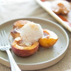 Three Oven Roasted Peach Halves with Balsamic Cream and Ice Cream on a Plate