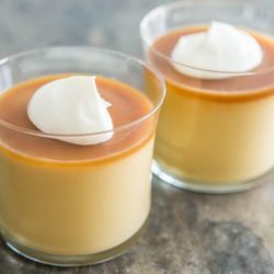 Budino in Two Glasses with Butterscotch Sauce and Dollop of Cream