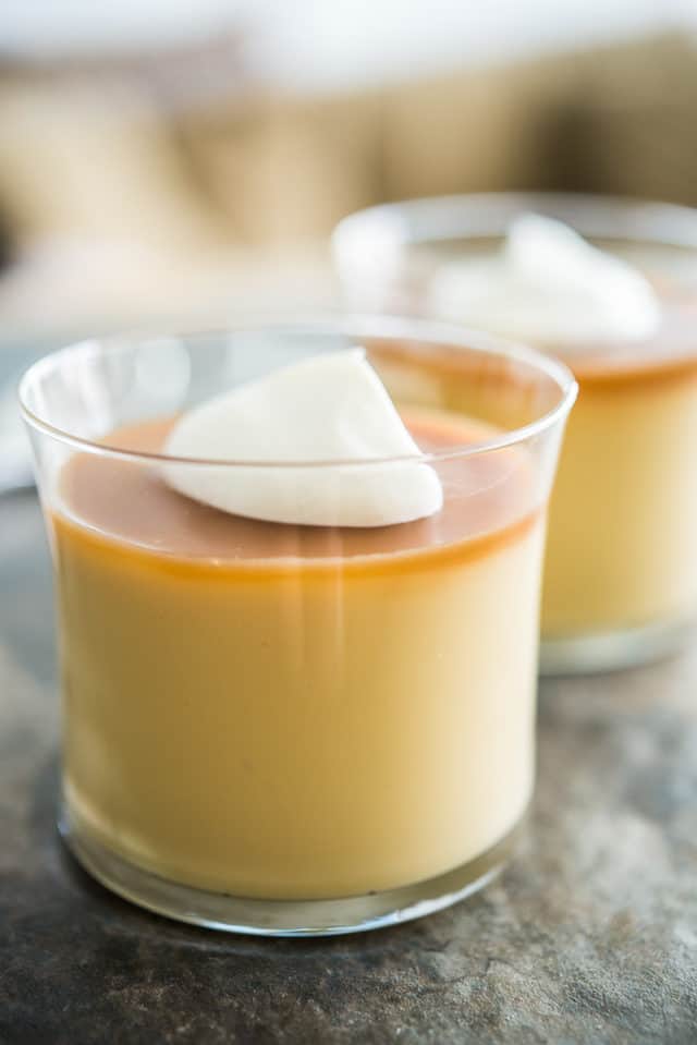 Two Butterscotch Budino Glasses with Dollops of Cream