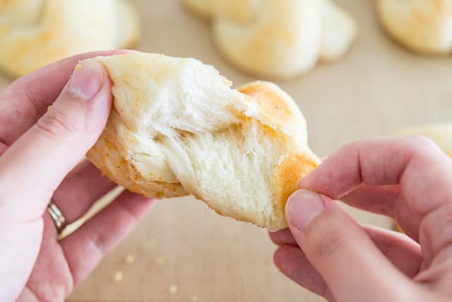 Tearing Apart a Fluffy Garlic Knot to Show Soft Interior