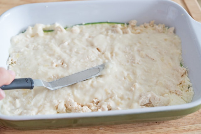 Spreading Bechamel Sauce on Top of Chicken with offset Spatula