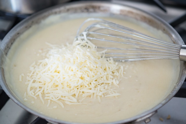 Bechamel Sauce in Skillet with Cheese Shreds