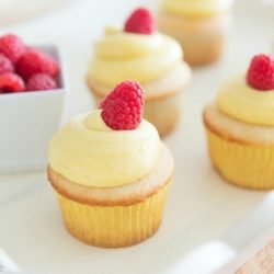 Framboise Cupcakes Piped With French Vanilla Buttercream On Top and Raspberries