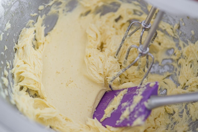 Smoothing French Buttercream Frosting with Spatula in Mixing Bowl