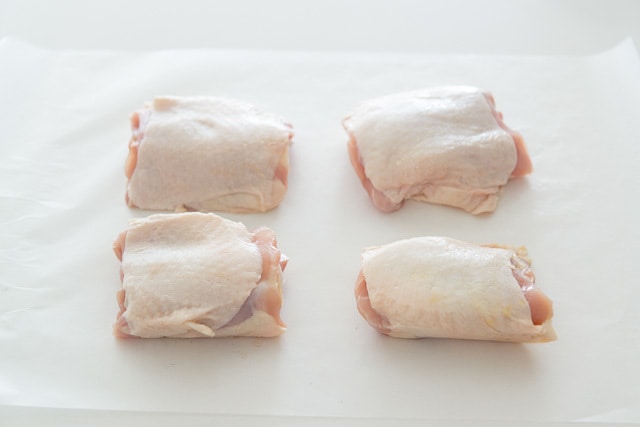 Four Chicken Thighs on Wax paper