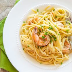 Shrimp Linguine Served in White Bowl With White Wine, Tomatoes, and Herbs