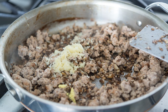 Ground Turkey in a Skillet with minced Garlic and Ginger Added