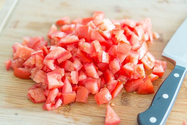 Chopped Seeded Roma Tomatoes on Cutting board