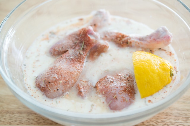 Marinating Chicken Drumsticks with Buttermilk and Lemon in Bowl