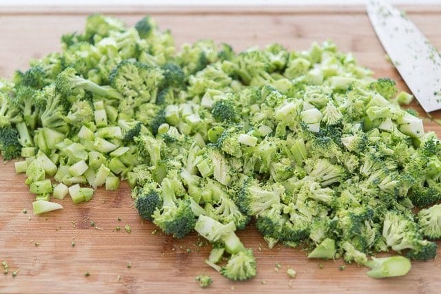 Fresh broccoli florets chopped on wooden board