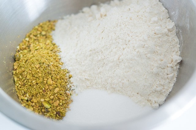 Flour, Ground up Pistachios, and Sugar in Mixing Bowl