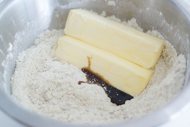 Dry Ingredients in Bowl with Two Sticks of Butter and vanilla
