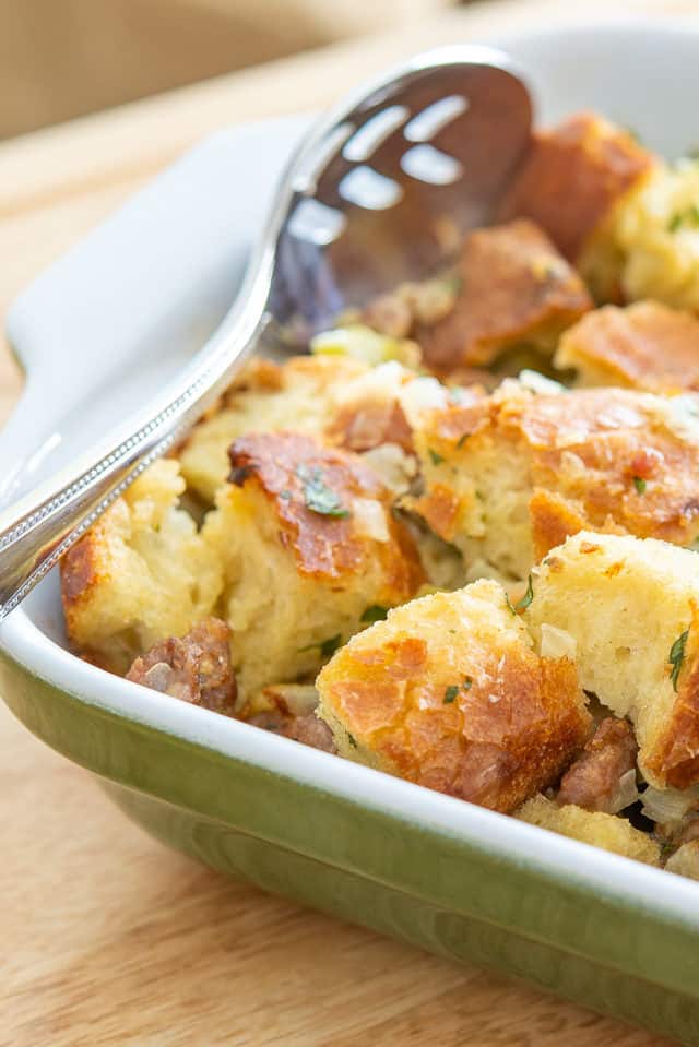 Thanksgiving Stuffing Recipe - In a Green Casserole Dish with Spoon