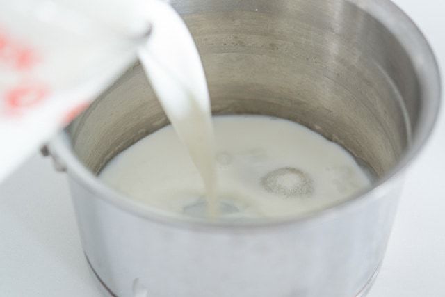 Pouring Milk Into Saucepan