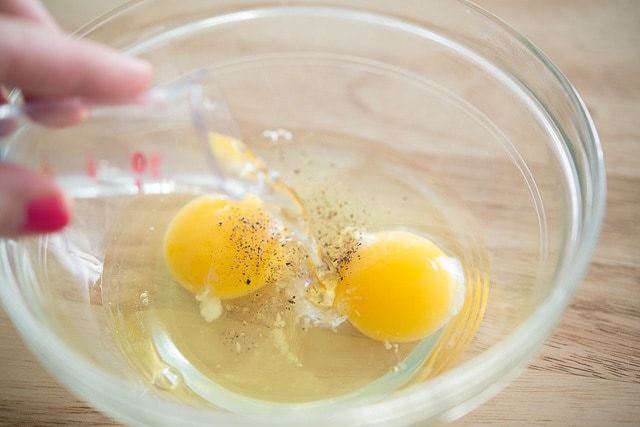Pouring water Into Bowl with Eggs, Salt, and Pepper