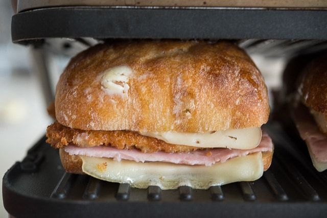 Chicken Panini Recipe - Being Pressed in Panini Grill with Ham, Swiss, and Mustard