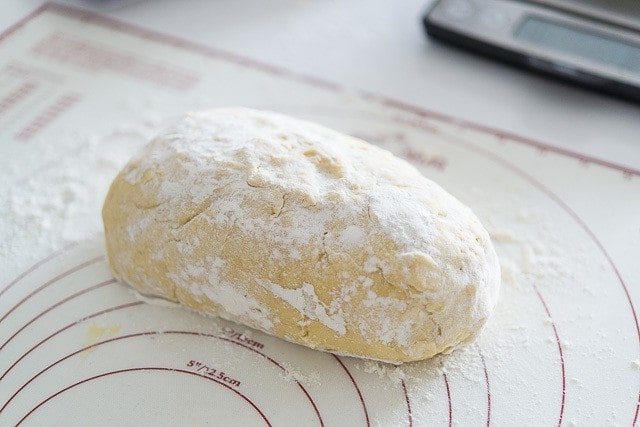 Bread Dough Dusted with Flour on Rolling Mat